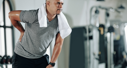 Man in back pain in the gym