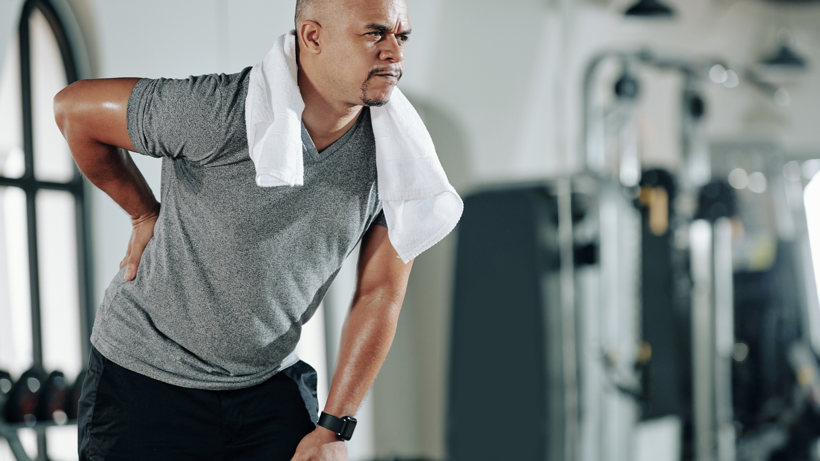 Man in back pain in the gym